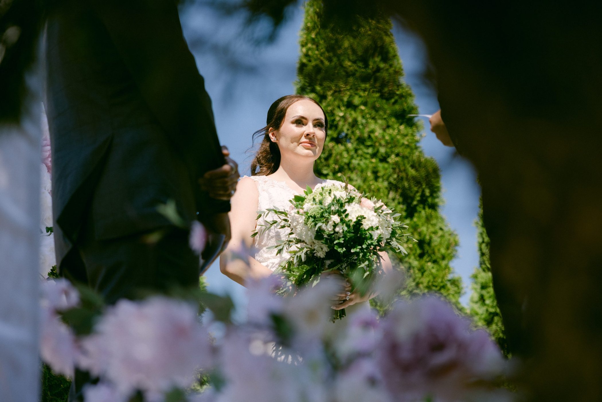 Olivia holding her bouquet in the garden