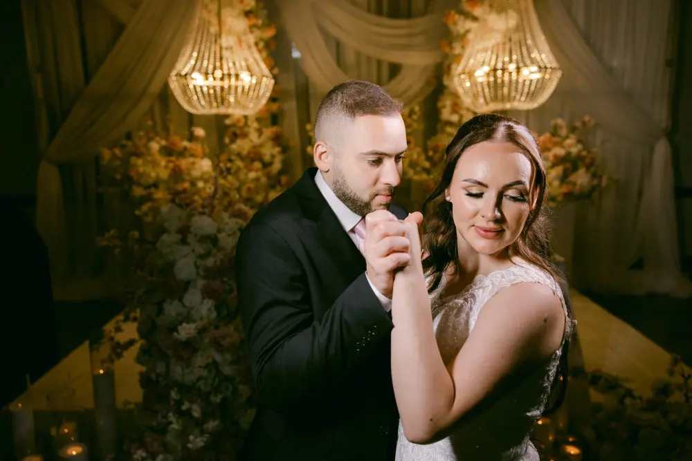 Olivia and Amro dancing close in warm golden light