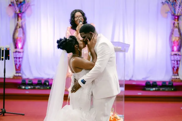 Sheronia and Zavan sharing their first kiss at the ceremony